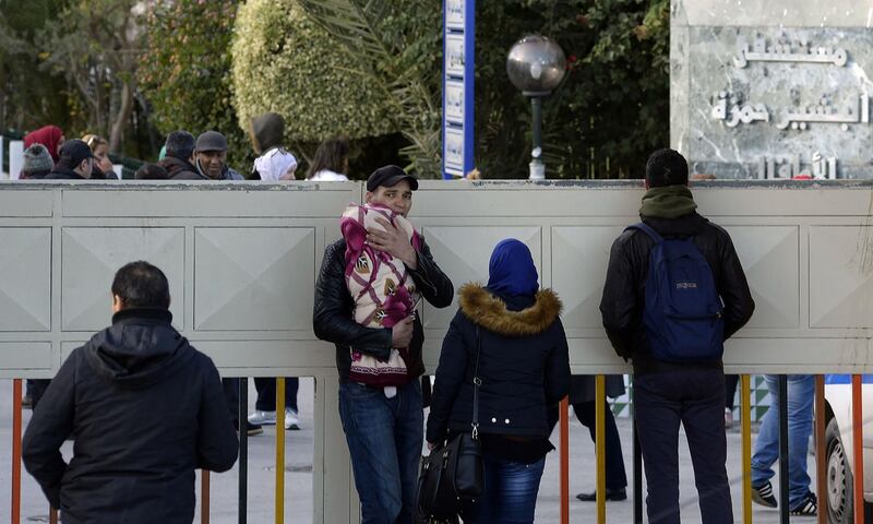 Citizens wait in front of a hospital during a general public strike. AFP