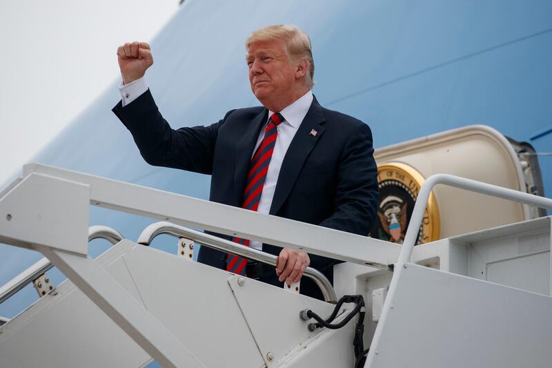 FILE - In this Sept. 21, 2018, file photo, President Donald Trump gestures as he arrives at Springfield-Branson National Airport before attending a campaign rally in Springfield, Mo. Trump polled staff, called his outside network of advisers and kept a careful eye on what his favorite hosts on his favorite network were recommending. The messages were mixed, but more were in favor of repressing the urge to fire Deputy Attorney General Rod Rosenstein, a move that would declare open warfare with the Justice Department and cast doubt on the future of the special counselâ€™s Russia probe. (AP Photo/Evan Vucci, File)