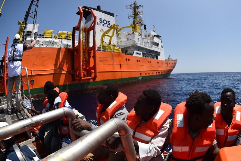 Refugees on  a boat after being rescued on May 24, 2016, by the Aquarius, a former North Atlantic fisheries protection ship now used by humanitarians SOS Mediterranee and Medecins Sans Frontieres (Doctors without Borders), in the Mediterranean sea in front of the Libyan coast. Gabriel Bouys / AFP  

