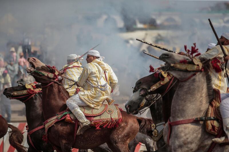 A troupe charges and fire their rifles during Tabourida, a traditional horse riding show also known as Fantasia, in the coastal town of El Jadida, Morocco.