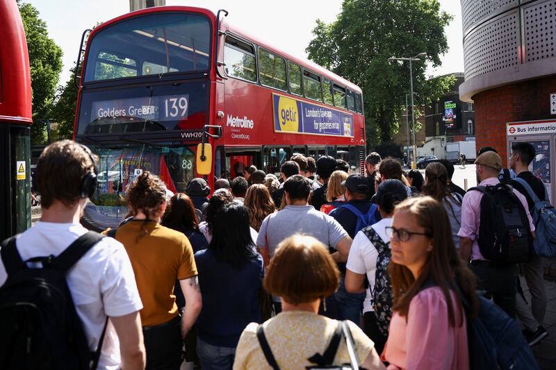 Passengers queue for a bus outside Waterloo station. Reuters