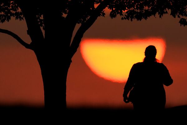 A woman watches the sun set in Kansas City, Missouri. AP