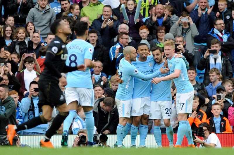 Manchester City's Bernardo Silva, 2nd right, celebrates with teammates after scoring his side's fourth goal during the English Premier League soccer match between Manchester City and Swansea City at Etihad stadium in Manchester, England, Sunday, April 22, 2018. (AP Photo/Rui Vieira)