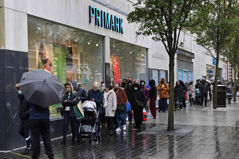 Shoppers queue to enter a Primark store in Liverpool. AFP
