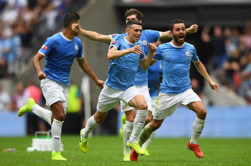 City's players celebrate their success. Getty