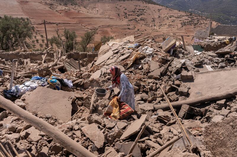 Villagers among the rubble of destroyed buildings near Amizmiz, in El Haouz region. Bloomberg
