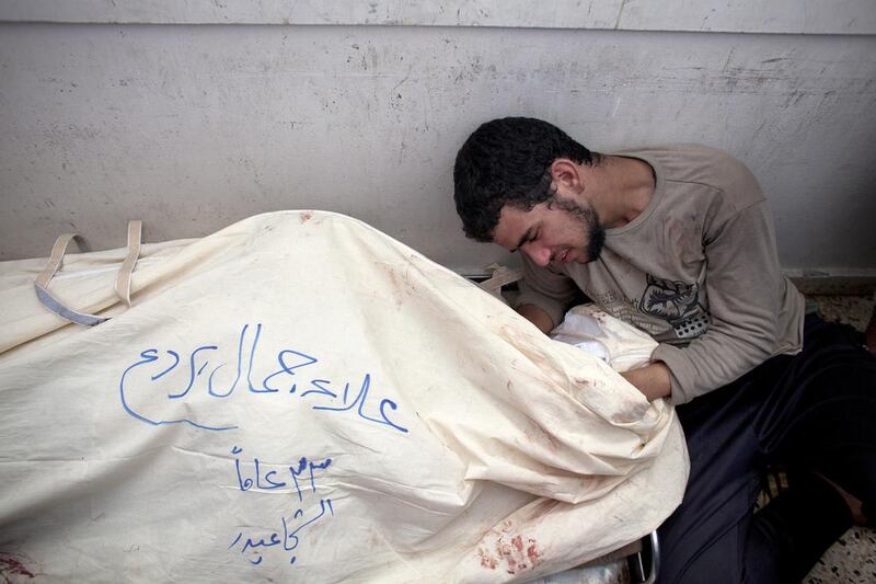 A man mourns over his dead relative at the morgue in  Shifa Hospital in Gaza City. At least 66 Palestinians were killed in the Shujaieh neighbourhood, which was heavily shelled by Israel during fighting, in Gaza City on July 20, 2014. Heidi Levine for The National
