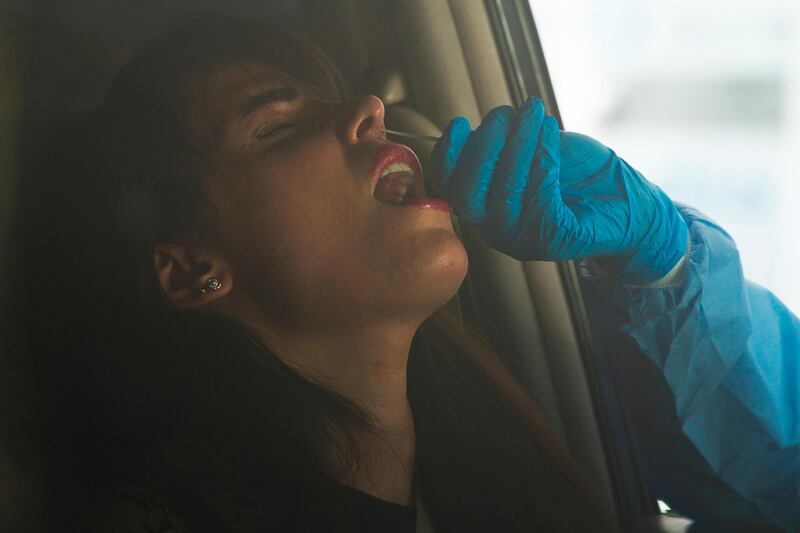 A woman undergoes a nasal swab.