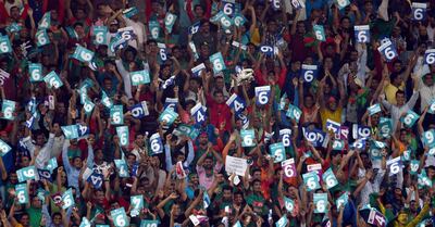 Bangladeshi cricket fans cheer in support of their national team during the one day international (ODI) Asia Cup cricket match between Bangladesh and Sri Lanka at the Dubai International Cricket Stadium in Dubai on September 15, 2018. / AFP / ISHARA S. KODIKARA
