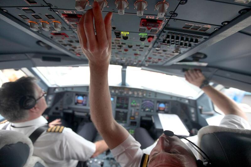 The Etihad captains Francois Lacombe, left, and  Oliver Iffert perform preflight checks before a flight from France to Abu Dhabi. Sammy Dallal / The National