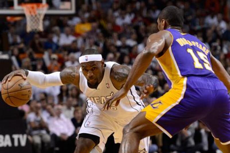 LeBron James looks for a way past Los Angeles Lakers forward Metta World Peace.