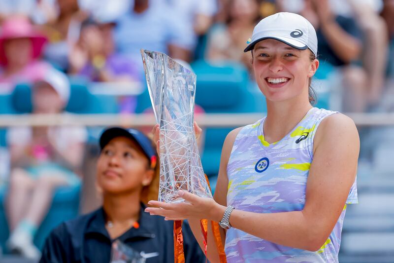 Iga Swiatek holds the Butch Buchholz Trophy after defeating Naomi Osaka in the Miami Open final. EPA