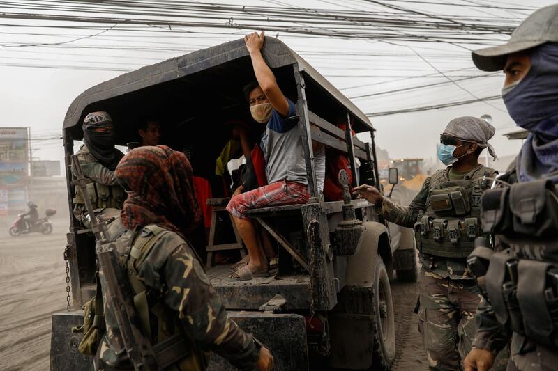 Residents living near the erupting Taal Volcano evacuate in Lemery, Batangas City. Reuters