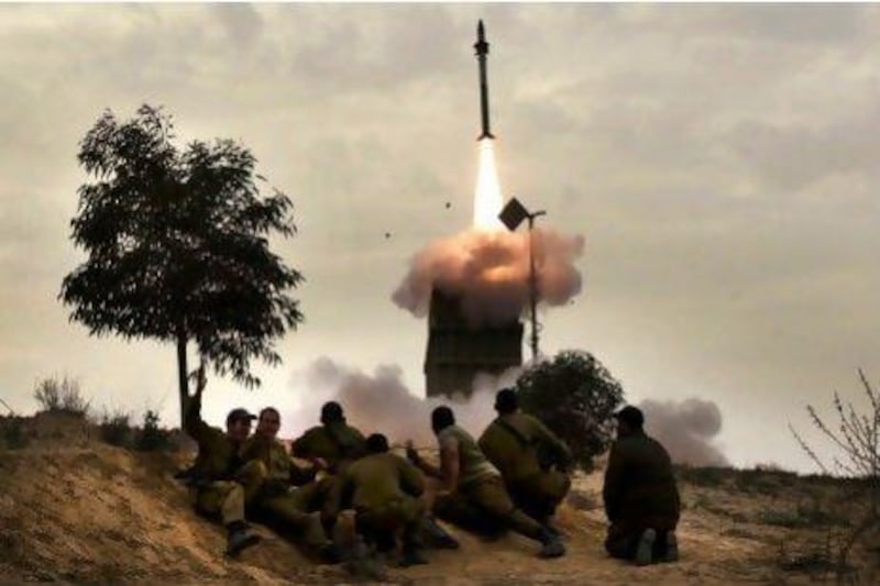Israeli soldiers watch a missile launch from the Iron Dome defence system in Beer Sheva.