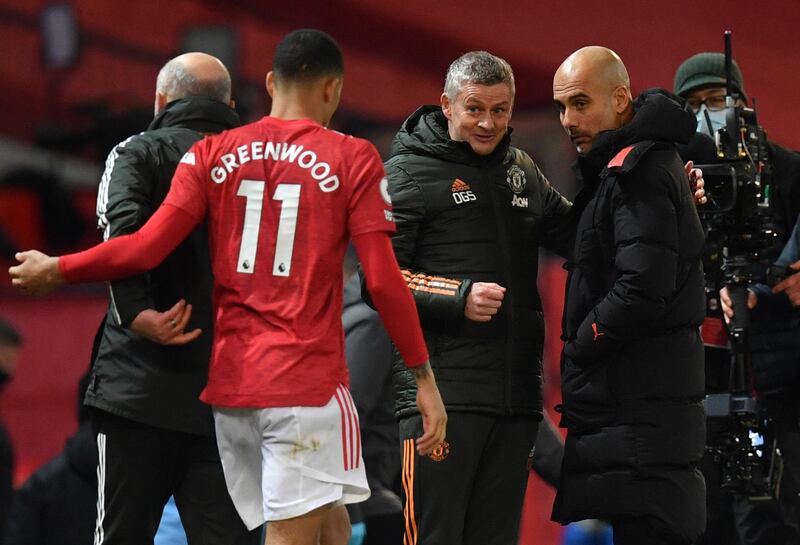 Solskjaer speaks to Manchester City's coach Pep Guardiola. AP