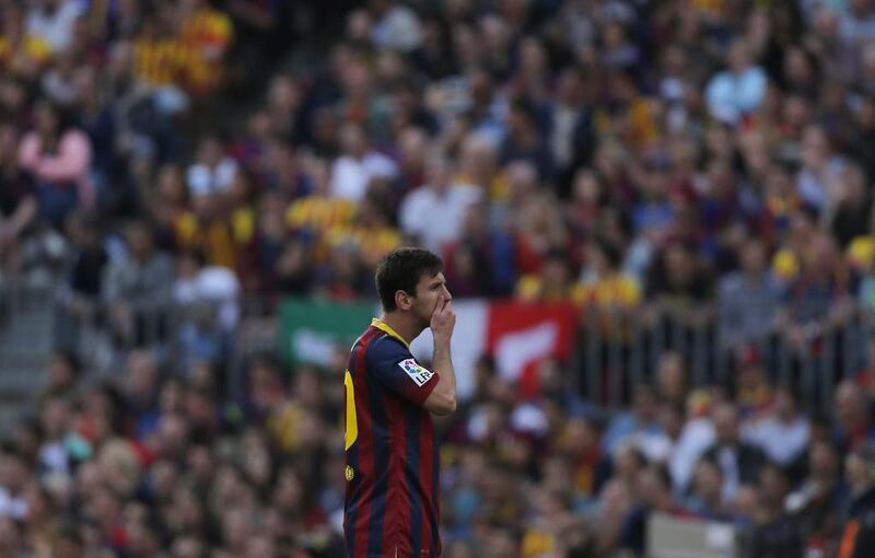 Barcelona forward Lionel Messi puts his hand on his mouth during his side's draw with Atletico Madrid on Saturday that cost them the La Liga title. Andres Kudacki / AP / May 17, 2014