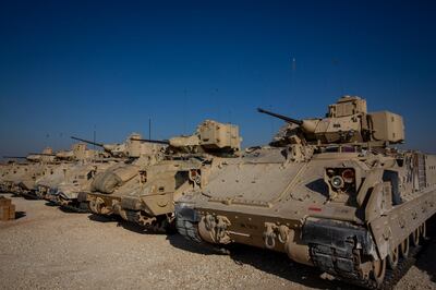 FILE - In this Nov. 11, 2019, file photo, Bradley fighting vehicles are parked at a U.S. military base at an undisclosed location in Northeastern Syria, Monday, Nov. 11, 2019. The U.S. has deployed additional troops and armored vehicles into eastern Syria after a number of clashes with Russian forces, including a recent vehicle collision that injured four American service members. (AP Photo/Darko Bandic, File)