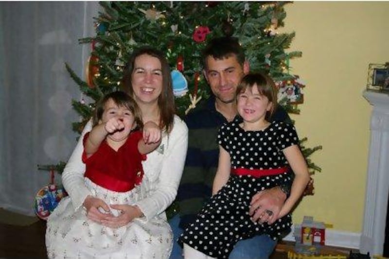 Captain David Thompson at home with his wife Emily, left, and daughters Isabelle and Abigail in North Carolina in 2009. Thompson was killed in January 2010 by Nasir Ahmad Ahmadi, a contract interpreter on his base in Afghanistan. Thompson Family / AP Photo