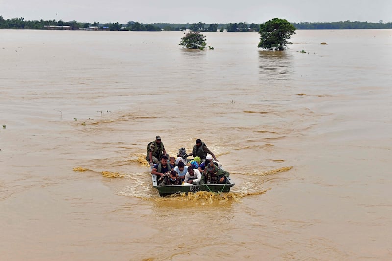 Army soldiers evacuate villagers after heavy rains in the Hojai district of Assam. AFP