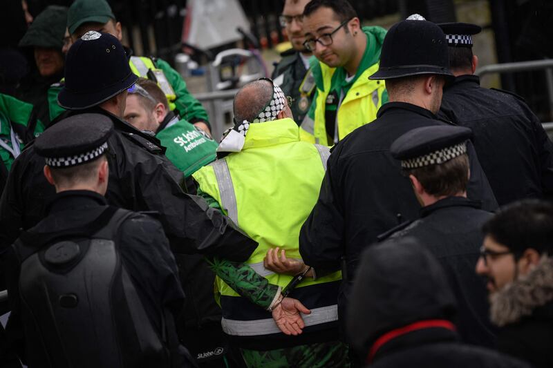 Police make an arrest near the coronation procession between Buckingham Palace and Westminster Abbey. AFP