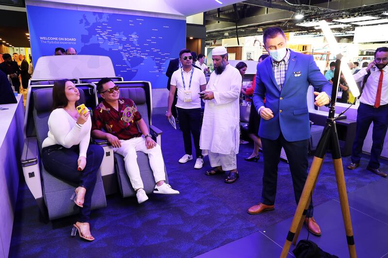 Visitors take photos at the flydubai stand. Pawan Singh / The National