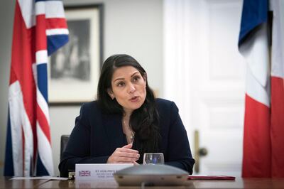 Home Secretary Priti Patel at the Home Office in central London, where she signed a new agreement with her French counterpart Gerald Darmanin aimed at curbing the number of migrants crossing the English Channel in small boats, Saturday Nov. 28, 2020.  The lawmakers met via a video Internet link, agreeing to double the number of French police patrolling a 150km stretch of coastline in northern France in an attempt to stop people crossing the English Channel in small boats. (Stefan Rousseau/PA via AP)