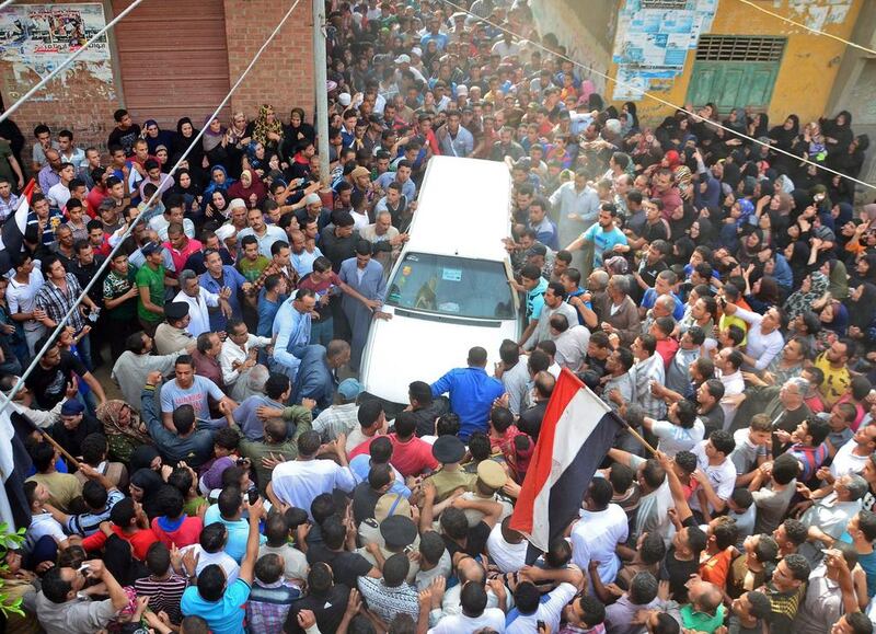 Mourners gather during the funeral procession of Mahmud al-Sayed al-Dakruri, who was killed when supporters of Egypt’s ousted president Mohamed Morsi and police clashed outside Cairo’s al-Azhar university, in the province of Dakhaliya. Sayed Baz / AFP