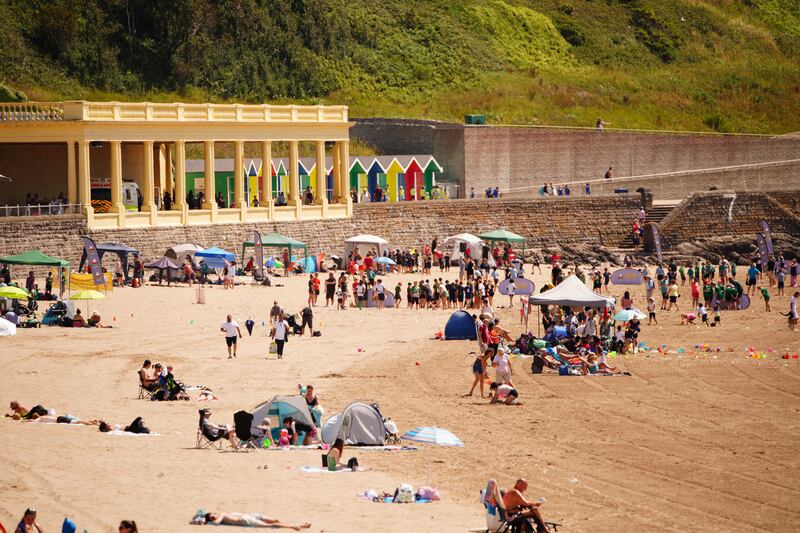 People on the beach at Barry Island, Wales. PA