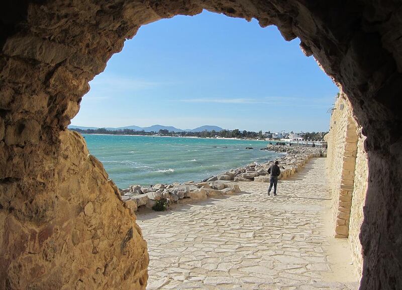 A visitor walks below the walls of the 13th-century Kasbah, or fort, in the Tunisian resort of Hammamet. Elizabeth Young for The National

