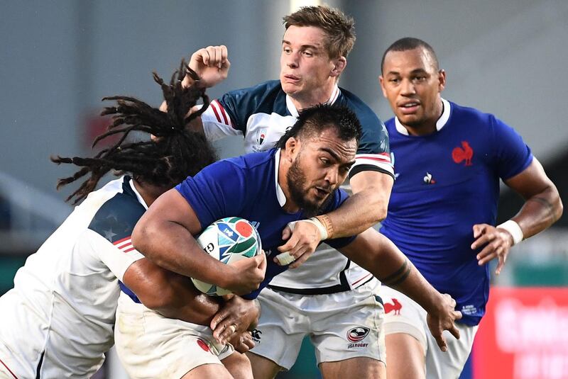 France's prop Emerick Setiano (R) is tackled by US fly-half AJ MacGinty (C) and US hooker Joseph Taufete'e (L)  during the Japan 2019 Rugby World Cup Pool C match between France and the United States at the Fukuoka Hakatanomori Stadium in Fukuoka. AFP