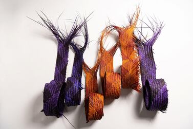 The traditional safeefah, or palm-frond weaving, technique has been braided with strands of camel leather to produce sculptural handbags. Courtesy Irthi Contemporary Crafts Council