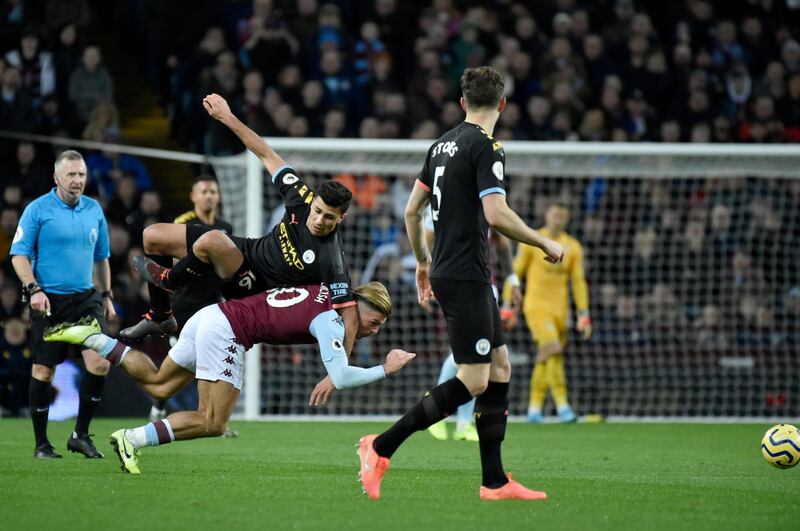 Manchester City's Rodrigo, top, fights for the ball with Aston Villa's Jack Grealish on Sunday. AP