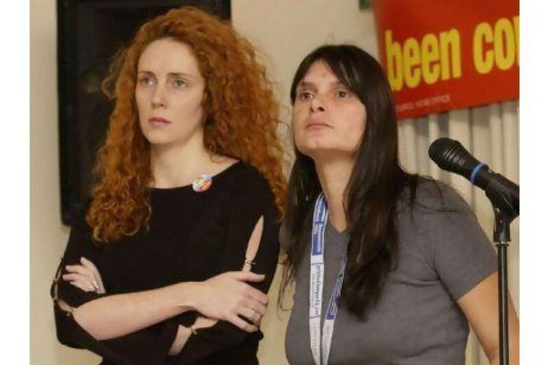 FILE - Oct. 8 2002 file photo of former News International Chief Executive Rebekah Brooks (at the time Rebekah Wade), left, standing next to Sara Payne, mother of murdered girl Sarah, who died at the hands of a paedophile. Brooks as editor of the News of the World was a high profile supporter of a law proposed by Payne to make public the whereabouts of sex offenders. Payne has been told by detectives that her contact details are on a list compiled by a private investigator used by the News of the World, currently being investigated for illegal phone hacking, it was reported