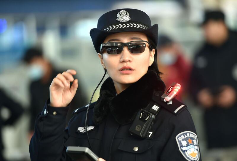 This photo taken on February 5, 2018 shows a police officer wearing a pair of smartglasses with a facial recognition system at Zhengzhou East Railway Station in Zhengzhou in China's central Henan province.
Chinese police are sporting high-tech sunglasses that can spot suspects in a crowded train station, the newest use of facial recognition that has drawn concerns among human rights groups. / AFP PHOTO / - / China OUT