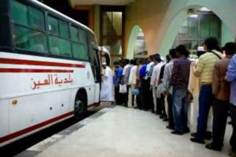 Abu Dhabi - September 30, 2008: People wait into the night for a bus out of town. On the first day of the  Eid al Fitr holiday the main bus terminal in Abu Dhabi is overwhelmed with people trying to leave town. Lauren Lancaster / The National

Note: these pictures are for this weeks Saloon in the Review.  *** Local Caption ***  LL_EidBus005.jpg