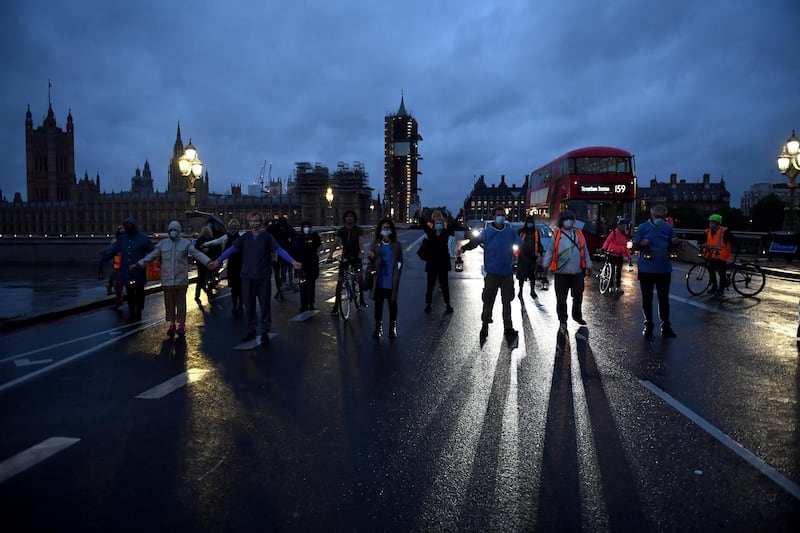 LONDON, ENGLAND - JULY 03: People wearing face masks and holding lanterns attend a vigil for the victims of the coronavirus on Westminster Bridge on July 3, 2020 in London, England. NHS Protest groups and workers carry out a socially distanced march from St Thomas's Hospital in Westminster to Downing Street where they will hold a candlelit vigil for  those who have died as a result of Covid-19. (Photo by Chris J Ratcliffe/Getty Images)