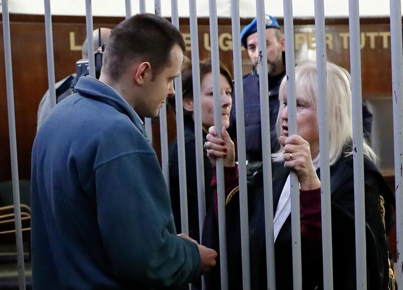 In this photo taken on Monday, Feb. 19, 2018, Lukasz Herba, left, talks to his lawyer Katia Kolakowska at a Milan court, Italy. A Polish man charged with kidnapping a British model for ransom has claimed she agreed to the ploy in a bid to boost her career. Lukasz Herba, testifying in his own defense at an Italian trial Wednesday, said 20-year-old Chloe Ayling didn't know that the kidnapping plot was afoot when she arrived in Milan for a modeling job in July. Herba said that he revealed it to her soon after, and that she agreed to it.  (AP Photo/Antonio Calanni)