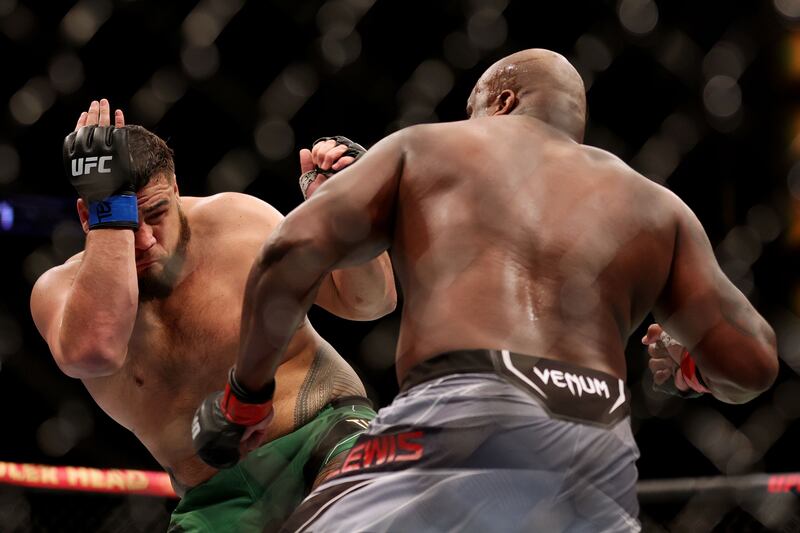 Tai Tuivasa takesa body shot from Derrick Lewis in their heavyweight fight at UFC 271. AFP