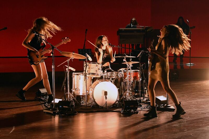 Este Haim, Alana Haim, and Daneille Haim of HAIM perform onstage during the 63rd annual Grammy Awards. Getty Images