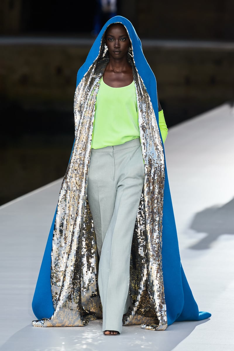 At Valentino autumn 2021 haute couture, a floor-length cape of cobalt blue is lined with silver shimmer
