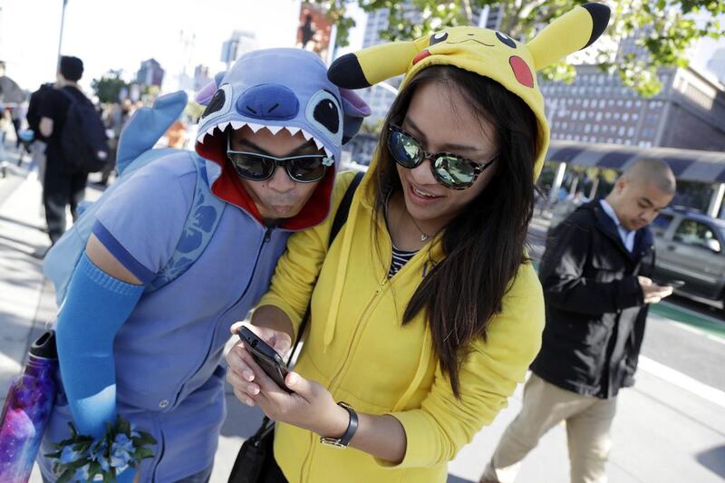 Pokemon-dressed characters hunt for virtual Pokemon in California. Marcio Jose Sanchez / AP