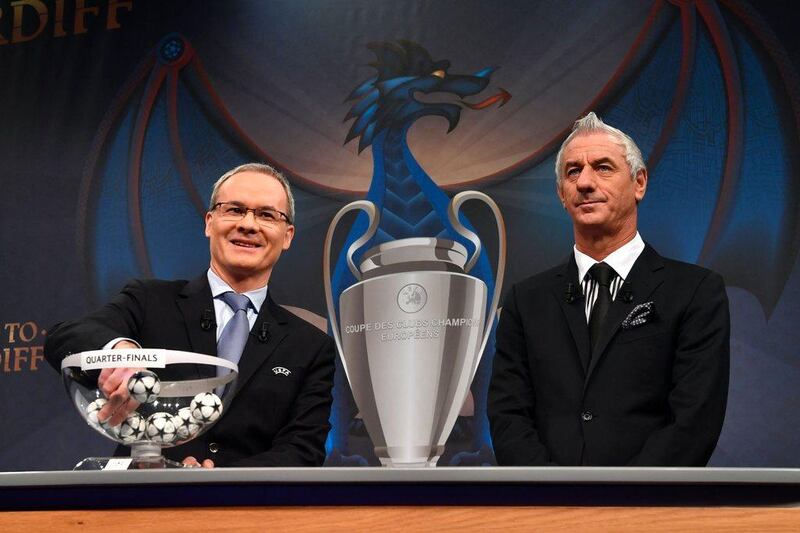 Former Liverpool striker Ian Rush, right, was on hand to help Uefa director of competitions Giorgio Marchetti with the Champions League quarter-final draw. Fabrice Coffrini / AFP