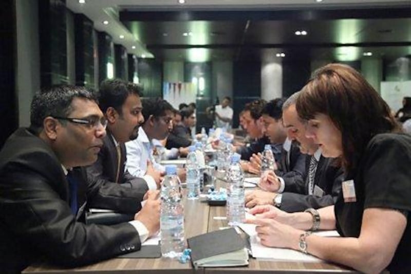 Entrepreneurs interact during a business speed-dating session in Dubai aimed at helping participants start trade partnerships. Lee Hoagland / The National