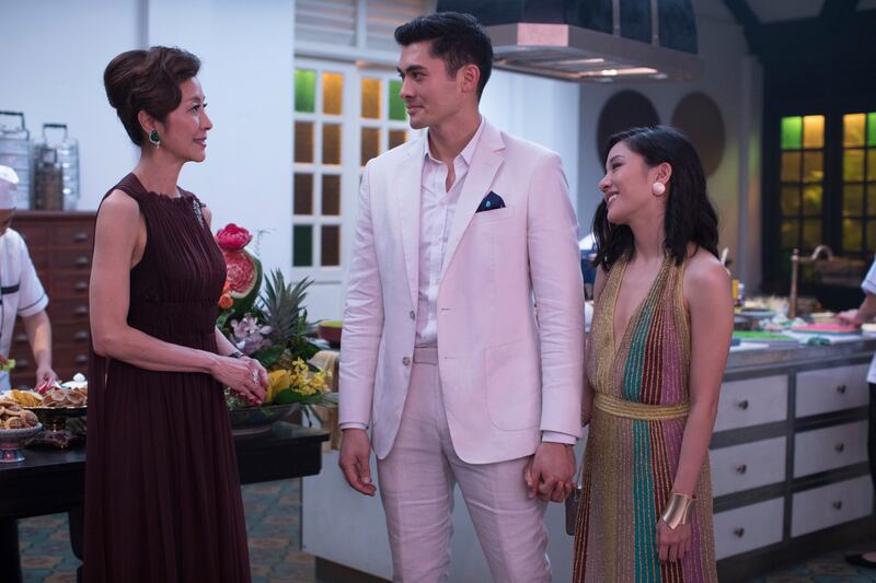 This image released by Warner Bros. Entertainment shows Michelle Yeoh, from left, Henry Golding and Constance Wu in a scene from the film "Crazy Rich Asians." (Sanja Bucko/Warner Bros. Entertainment via AP)