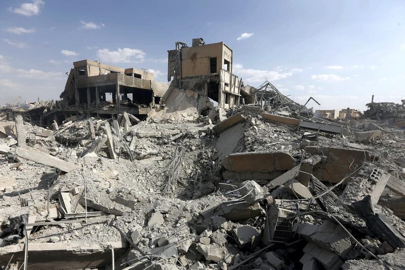 This picture taken on April 14, 2018 shows the wreckage of a building described as part of the Scientific Studies and Research Centre (SSRC) compound in the Barzeh district, north of Damascus, during a press tour organised by the Syrian information ministry.
The United States, Britain and France launched strikes against Syrian President Bashar al-Assad's regime early on April 14 in response to an alleged chemical weapons attack after mulling military action for nearly a week. Syrian state news agency SANA reported several missiles hit a research centre in Barzeh, north of Damascus, "destroying a building that included scientific labs and a training centre". / AFP PHOTO / LOUAI BESHARA