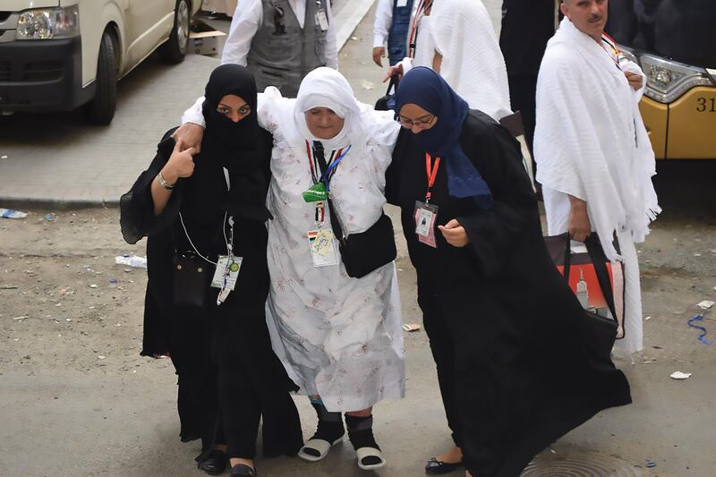 Aziza Kushak helps a pilgrim during Hajj in 2019.