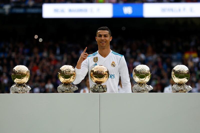 MADRID, SPAIN - DECEMBER 09: Cristiano Ronaldo of Real Madrid CF poses with his five Golden Ball (Ballon d'Or) trophies   prior to start the La Liga match between Real Madrid CF and Sevilla FC at Estadio Santiago Bernabeu on December 9, 2017 in Madrid, Spain . (Photo by Gonzalo Arroyo Moreno/Getty Images)
