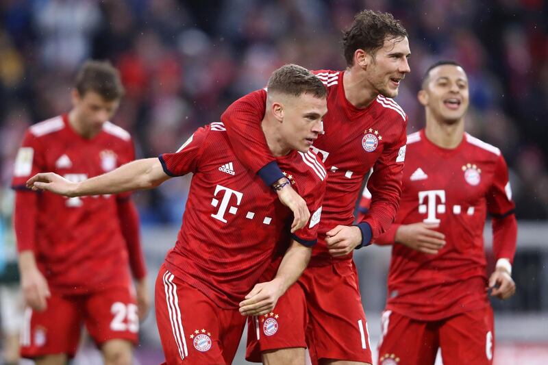 MUNICH, GERMANY - MARCH 09: Joshua Kimmich of Bayern Munich celebrates with teammate Leon Goretzka after scoring his team's fifth goal during the Bundesliga match between FC Bayern Muenchen and VfL Wolfsburg at Allianz Arena on March 09, 2019 in Munich, Germany. (Photo by Alex Grimm/Bongarts/Getty Images)