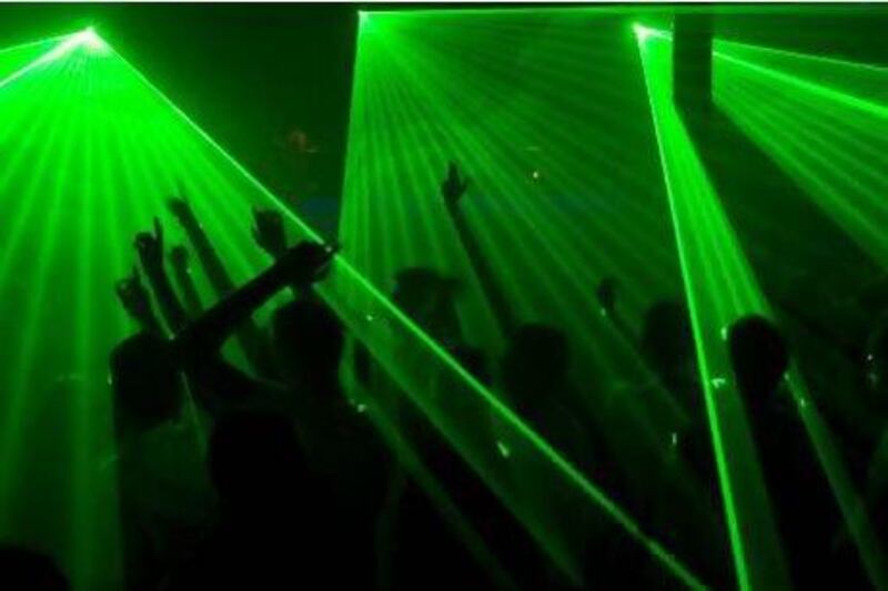 The spirit of disco: House music fans dance along to a laser light show. Getty Images