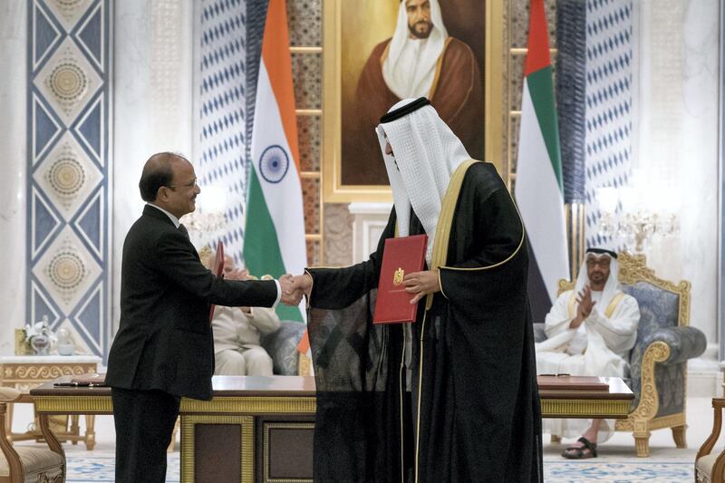 ABU DHABI, UNITED ARAB EMIRATES - February 10, 2018: HH Sheikh Mohamed bin Zayed Al Nahyan Crown Prince of Abu Dhabi Deputy Supreme Commander of the UAE Armed Forces (back R) and HE Narendra Modi, Prime Minister of India (not shown), witness an MOU signing pertaining to a concession agreement between the Supreme Petroleum Council and ADNOC. Seen signing are HE Dr Sultan Ahmed Al Jaber, UAE Minister of State, Chairman of Masdar and CEO of ADNOC Group (R) and Shashi Shanker, Chairman and Managing Director of the Oil and Gas Corporation Limited (L).

( Rashed Al Mansoori / Crown Prince Court - Abu Dhabi )
---